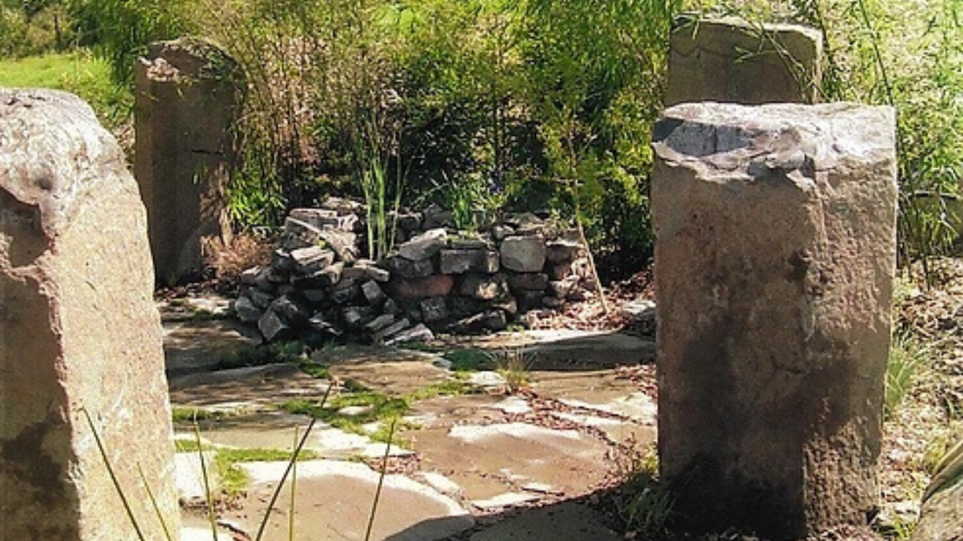 Ancient pool water feature encircled by large Stonehedge type Basalt columns. Award winner, Carmel Vally Garden Show.